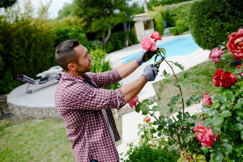 Team member in high-visibility jacket starting work in a garden